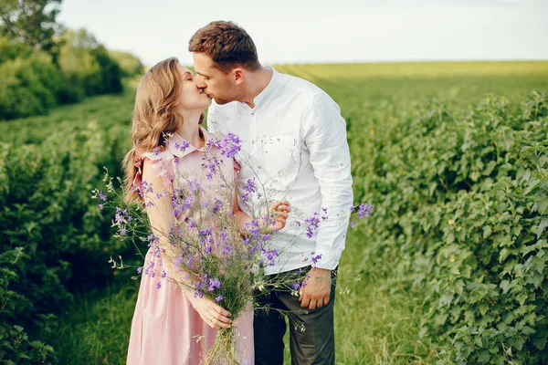 Beautiful couple spend time on a summer field — Stock Photo, Image