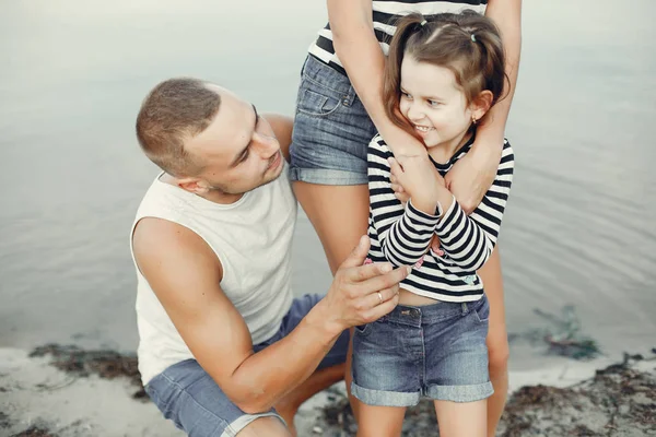 Family with daughter playing on a sand — Stock Photo, Image