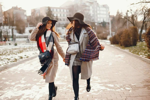 Zwei stylische Mädchen ruhen sich in einer Stadt aus — Stockfoto