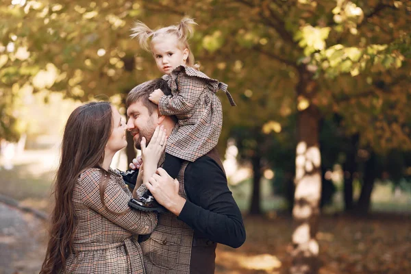 Family with little daughter in a autumn park — Stock Photo, Image