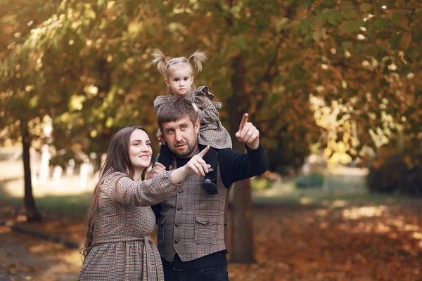 Family with little daughter in a autumn park — Stock Photo, Image