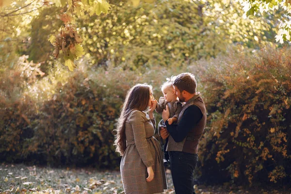 Family with little daughter in a autumn park — Stock Photo, Image