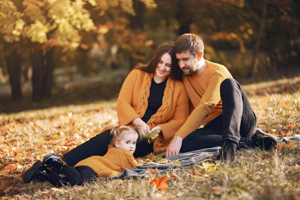 Family with little daughter in a autumn park — Stock Photo, Image