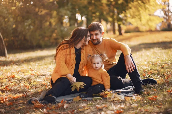 Family with little daughter in a autumn park — Stock Photo, Image