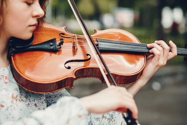 Красивая девушка в летнем парке со скрипкой — стоковое фото
