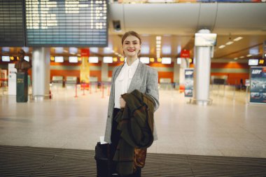 Havaalanında bavullu bir kadın var.