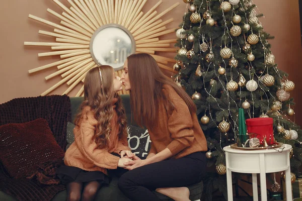 Mother with cute daughter near christmas tree — Stock Photo, Image