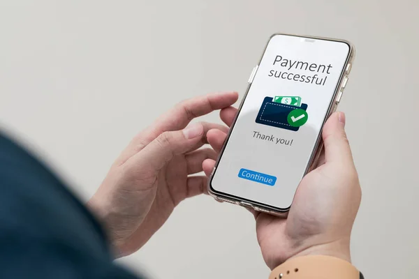 Payment successful notification system. Close-up view of customer smartphone using online banking application to pay for online purchases or merchandise in a department store.