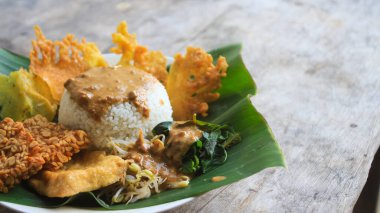 Yalnız bir tabak pecel pilavı. Menü katalogları için uygun. Nasi pecel veya sega pecel, Endonezya 'nın tipik bir pirinç yemeğidir. Ceviz biber sosu ve salata gibi sebzelerle servis edilir..