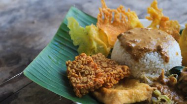 Yalnız bir tabak pecel pilavı. Menü katalogları için uygun. Nasi pecel veya sega pecel, Endonezya 'nın tipik bir pirinç yemeğidir. Ceviz biber sosu ve salata gibi sebzelerle servis edilir..