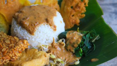 Yalnız bir tabak pecel pilavı. Menü katalogları için uygun. Nasi pecel veya sega pecel, Endonezya 'nın tipik bir pirinç yemeğidir. Ceviz biber sosu ve salata gibi sebzelerle servis edilir..