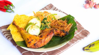 Ayam Bakar Kecap, Endonezya 'dan gelen tatlı ve baharatlı soya soslu ızgara tavuk yemeği. Acı sos (sambal), salatalık ve domatesle servis edilir. izole