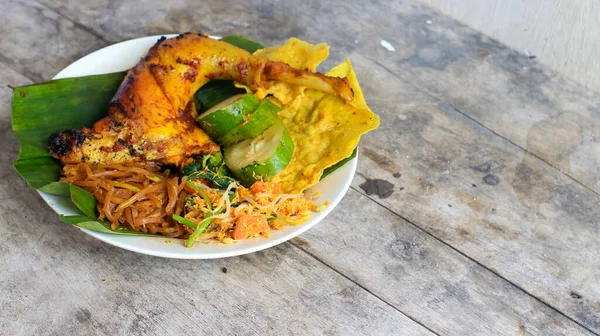 Ayam Bakar Kecap, Endonezya 'dan gelen tatlı ve baharatlı soya soslu ızgara tavuk yemeği. Acı sos (sambal), salatalık ve domatesle servis edilir. izole