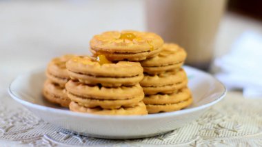 Kahvaltı ve atıştırmalık menü. Ananas reçelli tereyağlı bisküvi ve bir bardak çikolatalı süt. Tereyağlı kurabiye ve bir bardak çikolata, tatlı kekler. Tarifler, makaleler, kataloglar için mükemmel.