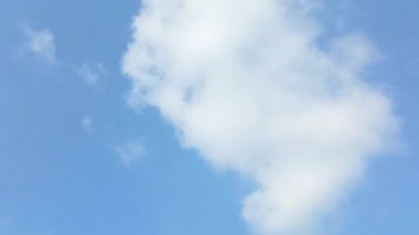 Parlak beyaz bulutlar parlak mavi gökyüzünde uçar. Gökyüzü öğleden sonra açık. Rüzgarda hareket eden bulutların arka plan görüntüsü. Boşluğu kopyala