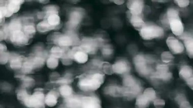 Soyut arka plan görüntüleri. Hareketli bokeh ışıkları lots. Güneşte parlayan deniz yüzeyinin defocused video.