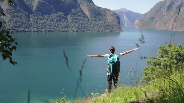 Fiatal nő egy nagy hátizsák állt a hegy szélén — Stock videók