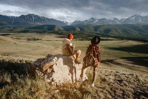 Gitar çalmak ve dağlar izlerken Çift gezgin