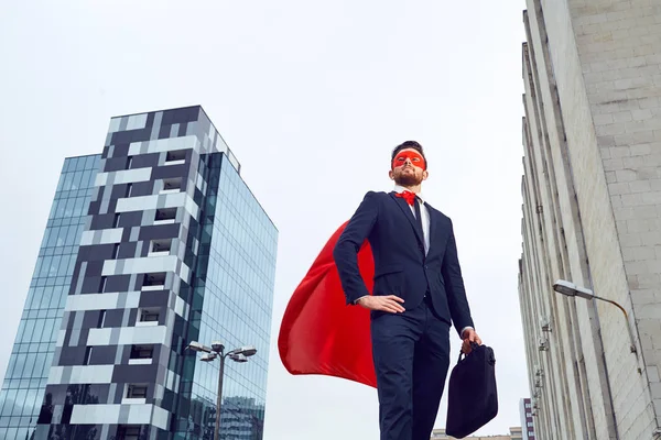 Egy üzletember egy szuperhős jelmez áll szemben egy üzleti b — Stock Fotó