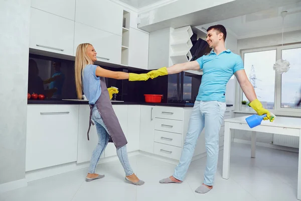 Um jovem casal está limpando um apartamento . — Fotografia de Stock