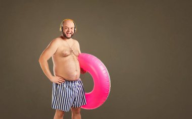 Yaz aylarında yüzme için bir daire ile komik şişman çıplak adam.