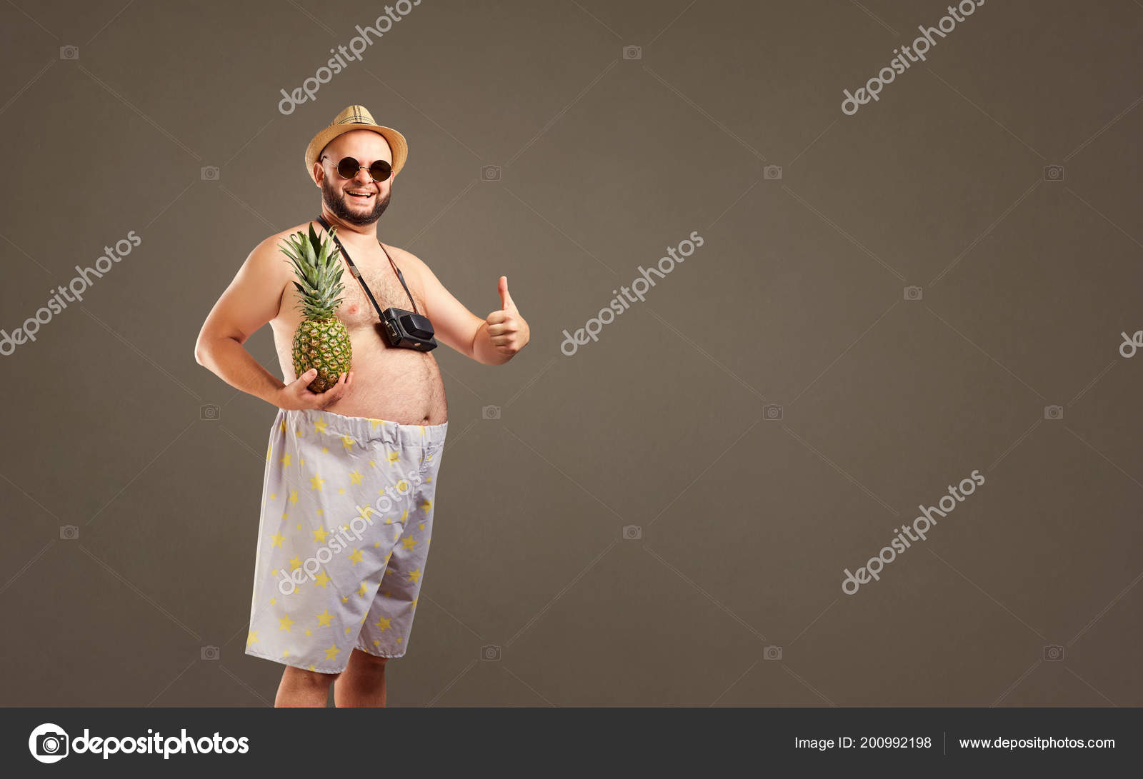 Funny fat man in a hat with pineapple smiling in — Stock