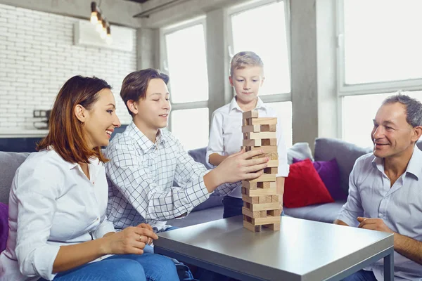 The family plays board games inside the room. — Stock Photo, Image