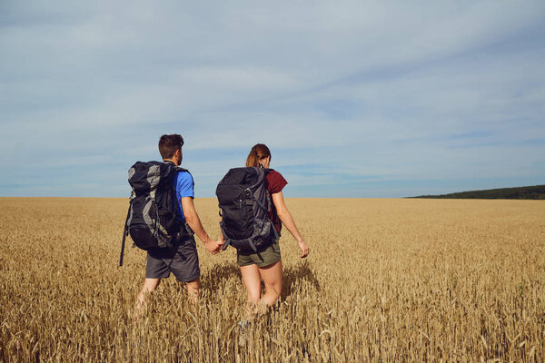 A man and a woman are tourists on the  field.