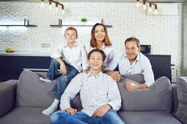 Mutlu aile odasında kanepede oturan gülümseyen.