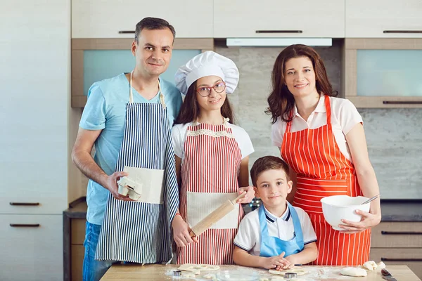 A happy family prepares baking in the kitchen