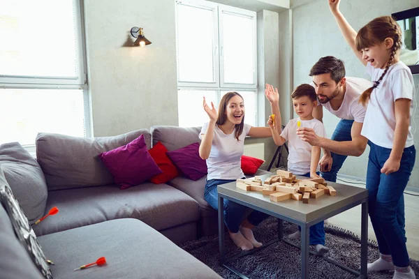 Mother, father and children play together.