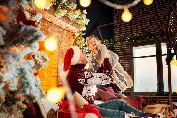 Father with a baby in a Christmas room. — Stock Photo, Image