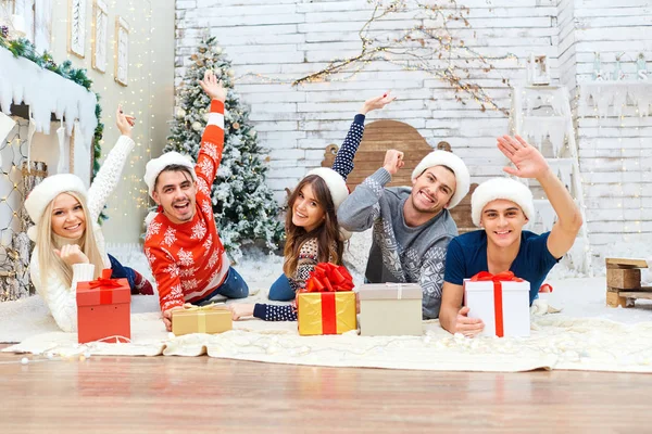 Um grupo de amigos com presentes em uma festa de Natal — Fotografia de Stock