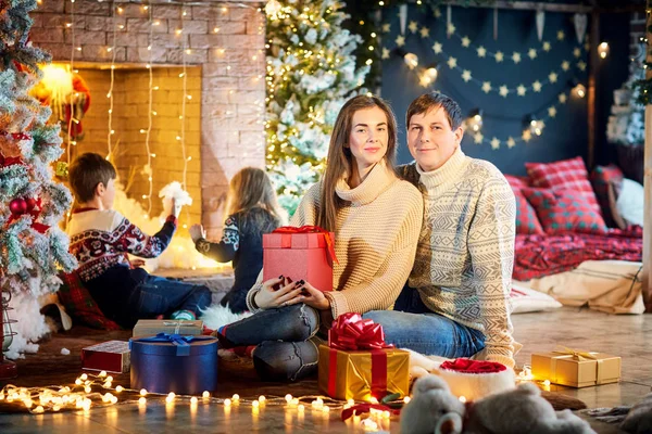 Family playing with gifts indoors on Christmas Day. — Stock Photo, Image