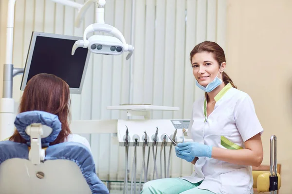 Female dentist smiling in the dental office — Stock Photo, Image