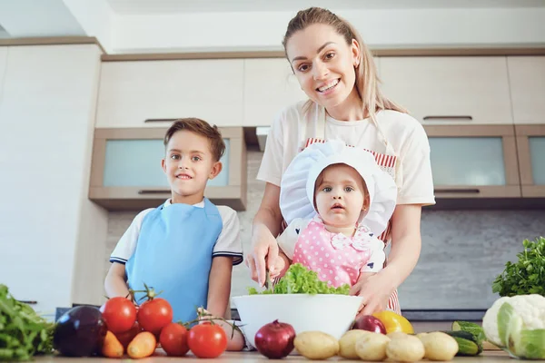 Mãe e filhos estão cozinhando na cozinha — Fotografia de Stock