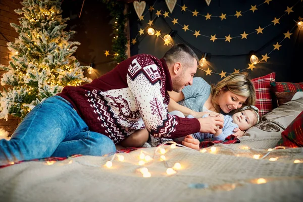 De familie met kind speelt binnenshuis op eerste kerstdag. — Stockfoto