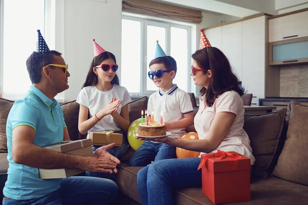 Lycklig familj med tårta på födelsedagsfest — Stockfoto