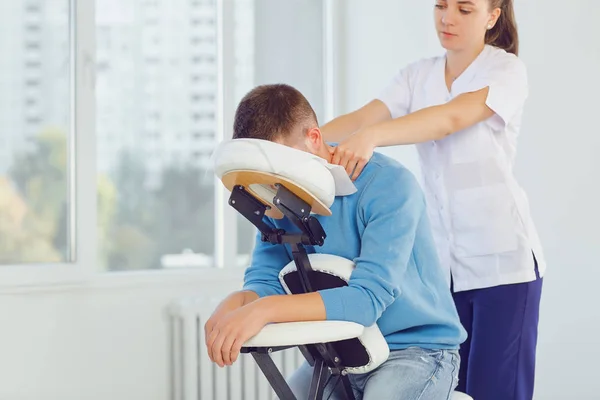 Massage on the massage chair in the office.