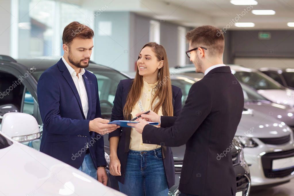  Sale, rental cars. A car dealer sells cars to customers.