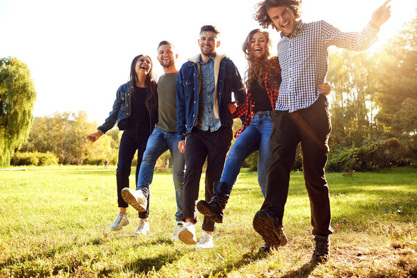 Group of happy friends are walking in the park.