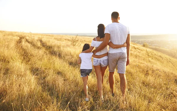 Mutlu aile yazın gün batımında doğada yürüyor.. — Stok fotoğraf