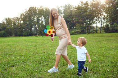 Bir çocuk ile anne parkta oynuyor.
