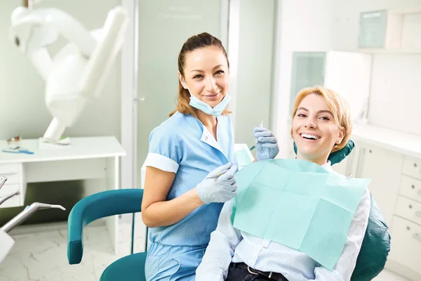 Dentist and patient girl are smiling. — Stock Photo, Image