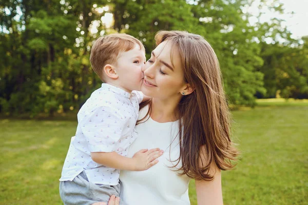 Mother and child play hugging in the park. — Stock Photo, Image