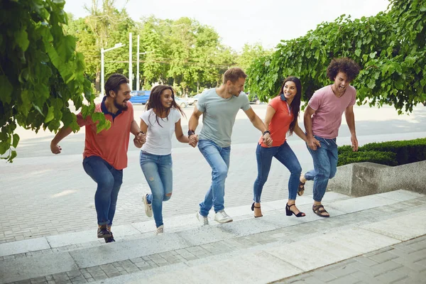 Gelukkige vrienden wandelen door de straten van een Europese stad. — Stockfoto