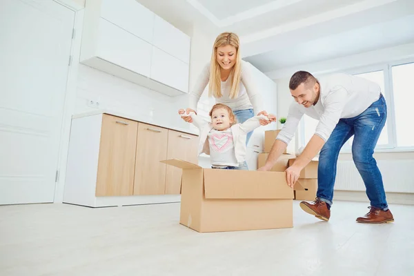 Happy family unpacking boxes at new home — Stock Photo, Image