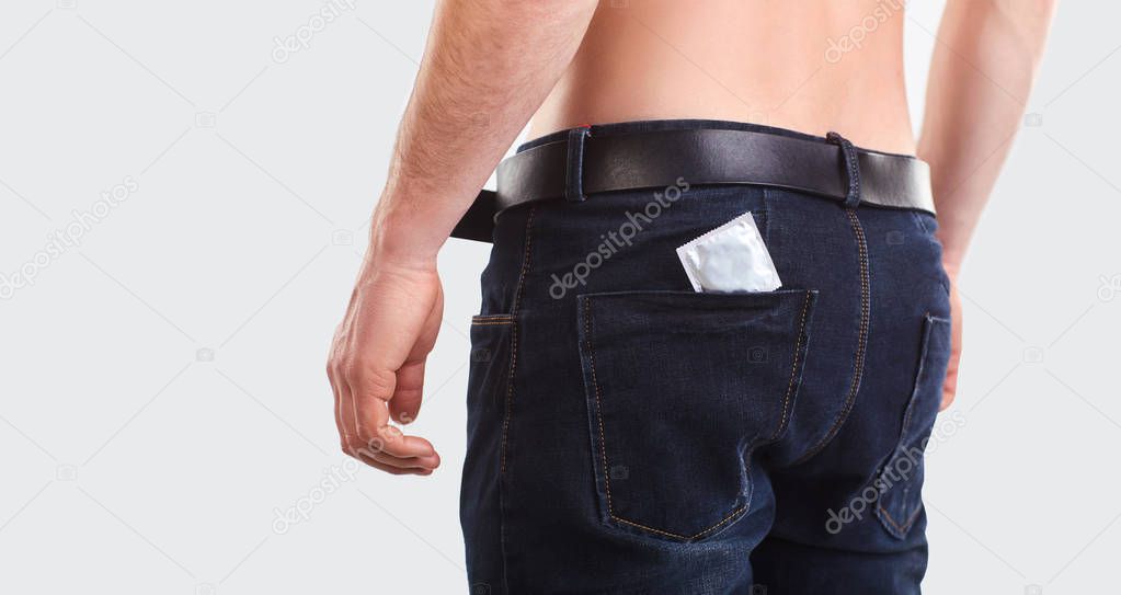 Condom in the pocket of men jeans