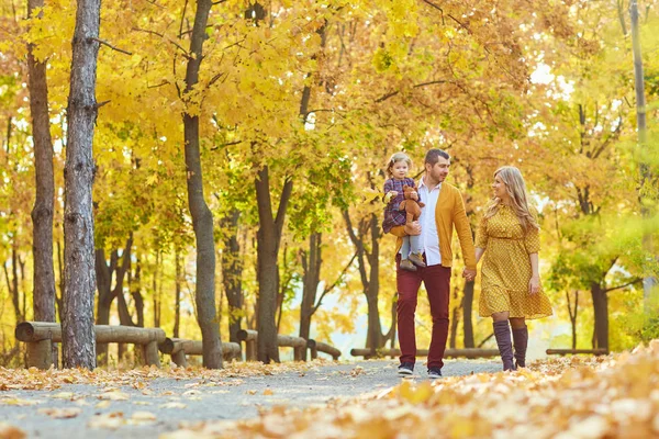 Rodzinny spacer w parku w żółtej jesieni. — Zdjęcie stockowe