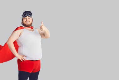 Funny fat man in a superhero costume raised thumb up. clipart